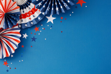 Concept for a patriotic Fourth of July party. Top view flat lay of patriotic decorations and star-shaped confetti on blue background with empty space for text or ad