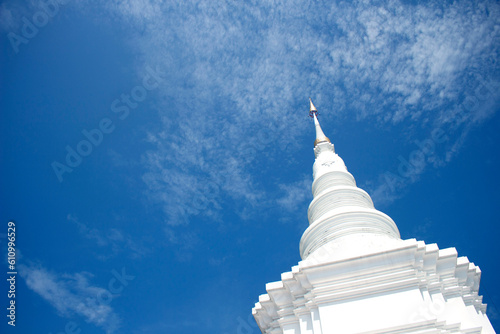 White pagoda on blue sky with white cloud background
