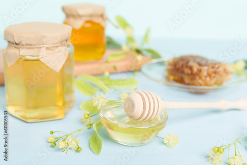 Linden honey with leaves and flowers on table