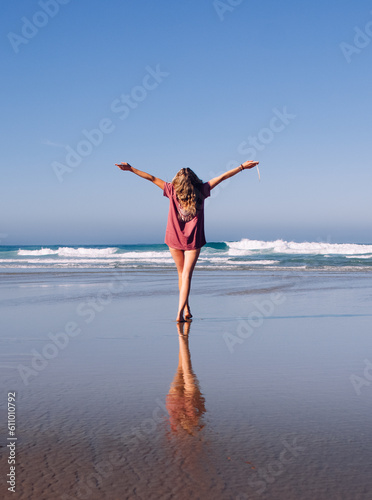 Girl frolicking on the beach