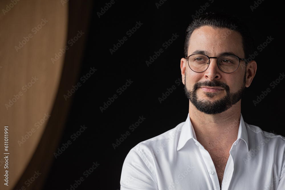 Obraz premium Portrait of handsome businessman against black background thinking