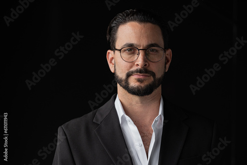 Portrait of handsome businessman against black background