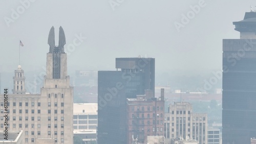 Poor air quality in Rochester NY caused by Canadian wildfire smoke over the city skyline dense around downtown office buildings due to climate change conditions in Canada