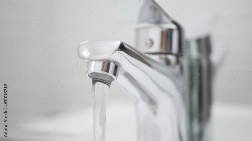 Hand Turn On Off the Tap Water on Sink, Faucet, Woman Stops Wasting Water, Inundation, Running Water for Washing in Bathroom Hand Turn On Off the Tap Water on Sink, Faucet, Woman Stops Wasting Water, Inundation, Running Water for Washing in Bathroom