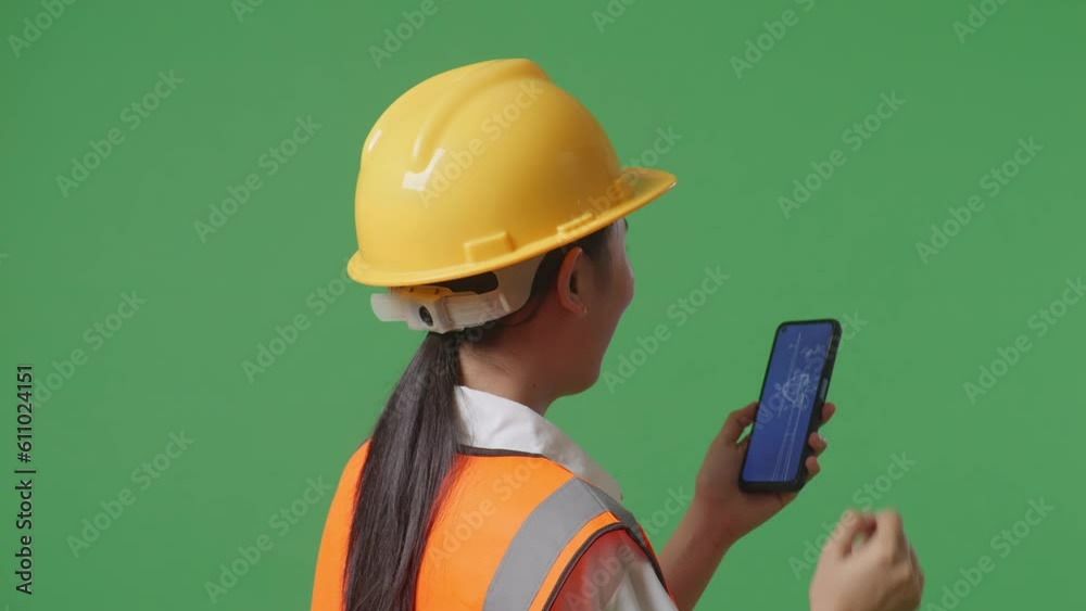 Close Up Back View Of Asian Female Engineer With Safety Helmet Looking At The Wind Turbine Blueprint On Smartphone While Standing In The Green Screen Background Studio
Close Up Back View Of Asian Female Engineer With Safety Helmet Looking At The Wind Turbine Blueprint On Smartphone While Standing In The Green Screen Background Studio