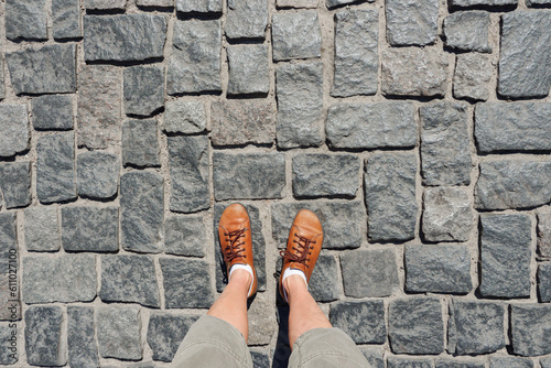 POV feet selfie legs walking street pavement top view. Abstract travel selfie shoes walking pavement stone pathway. Old street. Cobblestone pavement. Selfie foot path journey concept travel background