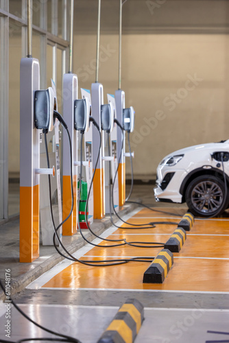 EV charging an electric car. Power supply for electric car charging. Socket for electric car battery charger. EV car charging station in car parking. Nature energy, Clean energy, Green eco concept.
