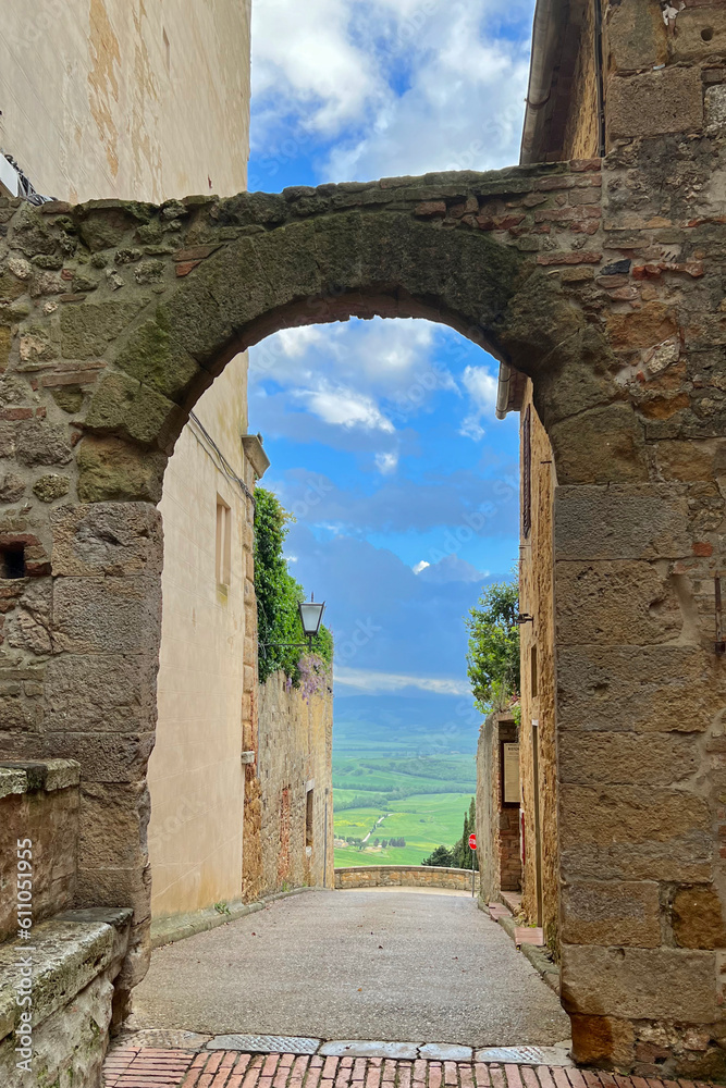 Narrow view of Val d'Orcia from the archway in Pienza, Italy