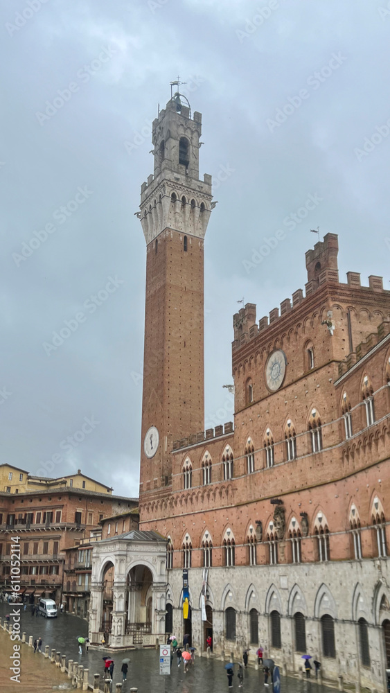 Siena, Italy - May 2023: Visiting Piazza del Campo and Torre del Mangia in Siena, Italy
