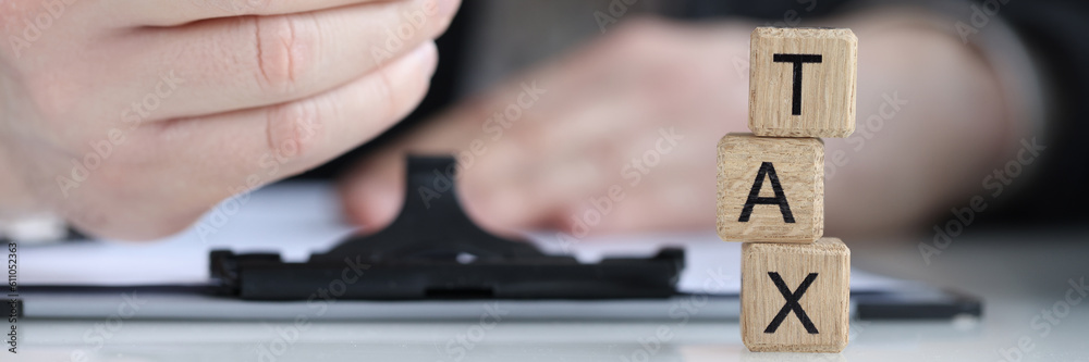 Tax word collected of wooden blocks letters in row Tax word collected of wooden blocks letters in row