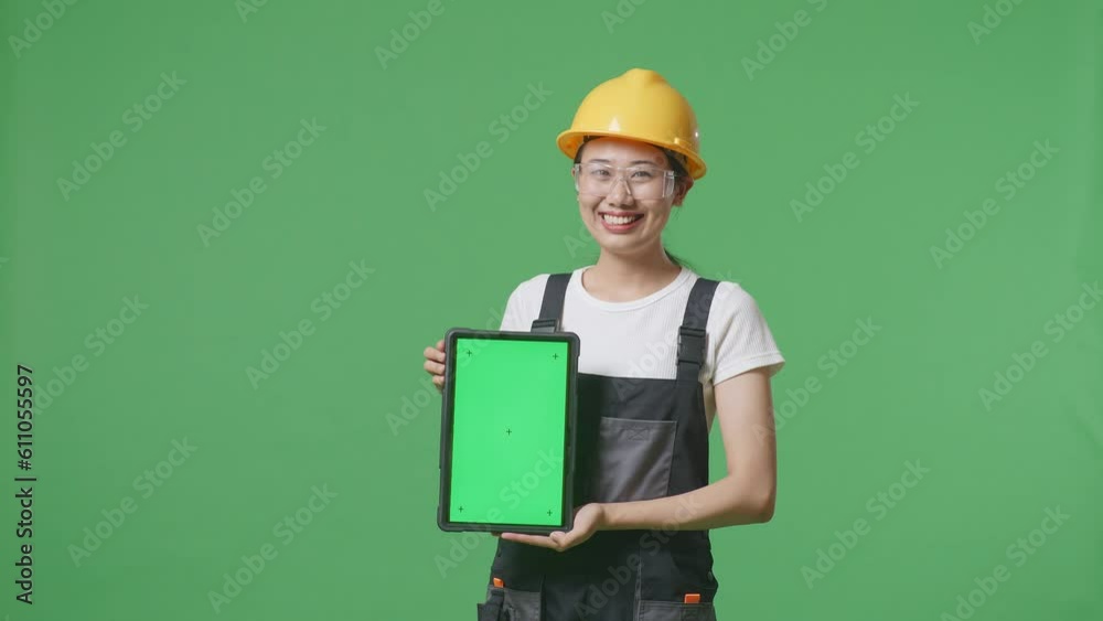 Asian Woman Worker Wearing Goggles And Safety Helmet Smiling And Showing Green Screen Tablet To The Camera While Standing In The Green Screen Background Studio
Asian Woman Worker Wearing Goggles And Safety Helmet Smiling And Showing Green Screen Tablet To The Camera While Standing In The Green Screen Background Studio