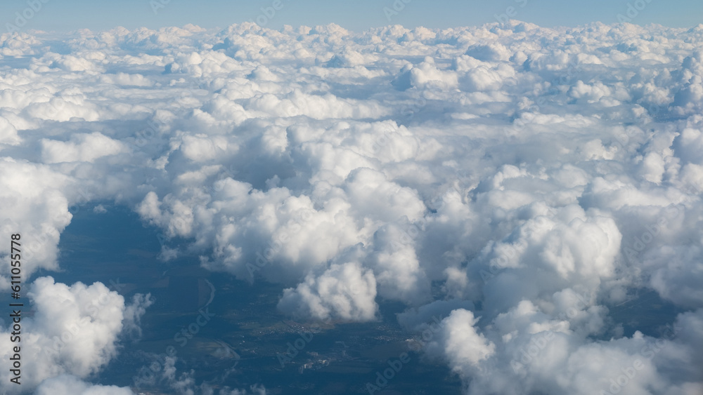 View of the white clouds from the airplane porthole. Travel concept View of the white clouds from the airplane porthole. Travel concept