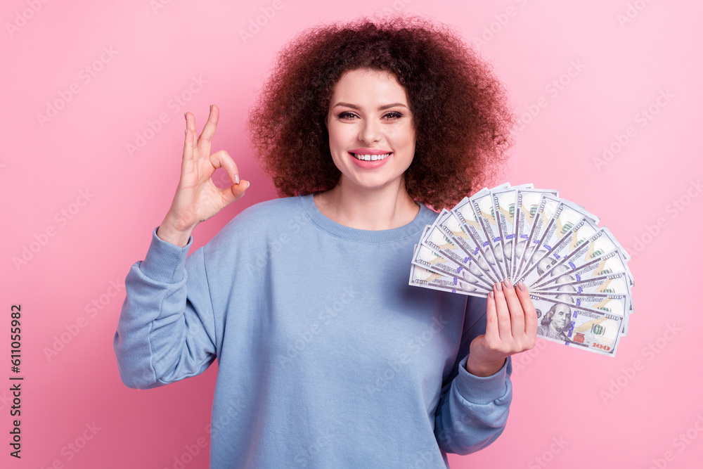 Photo of funky confident girl wear blue shirt rising money fan showing okey sign isolated pink color background Photo of funky confident girl wear blue shirt rising money fan showing okey sign isolated pink color background