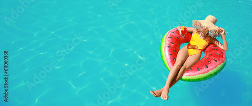 Beautiful young woman relaxing on inflatable ring in swimming pool. Banner for design