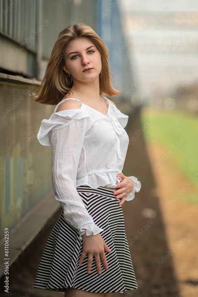 Portrait of a young beautiful blonde girl outdoors in summer.