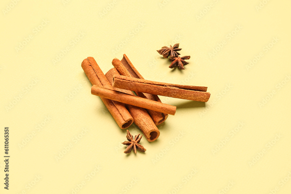 Cinnamon sticks with anise stars on color background Cinnamon sticks with anise stars on color background
