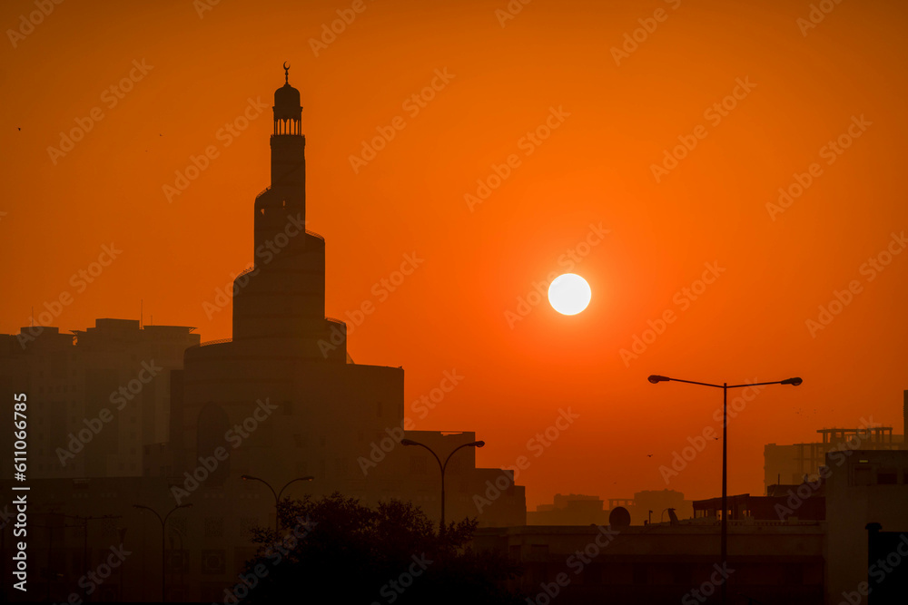 Fototapeta premium The silhouette Al Fanar tower mosque during the beautiful sunset in Doha, Qatar.