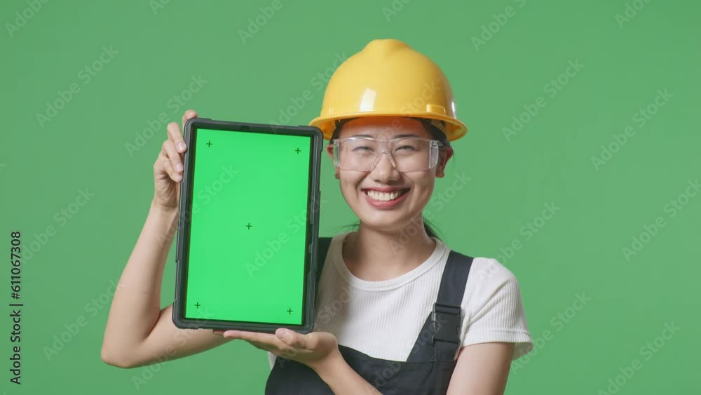 Close Up Of Asian Woman Worker Wearing Goggles And Safety Helmet Smiling And Showing Green Screen Tablet To The Camera While Standing In The Green Screen Background Studio
Close Up Of Asian Woman Worker Wearing Goggles And Safety Helmet Smiling And Showing Green Screen Tablet To The Camera While Standing In The Green Screen Background Studio