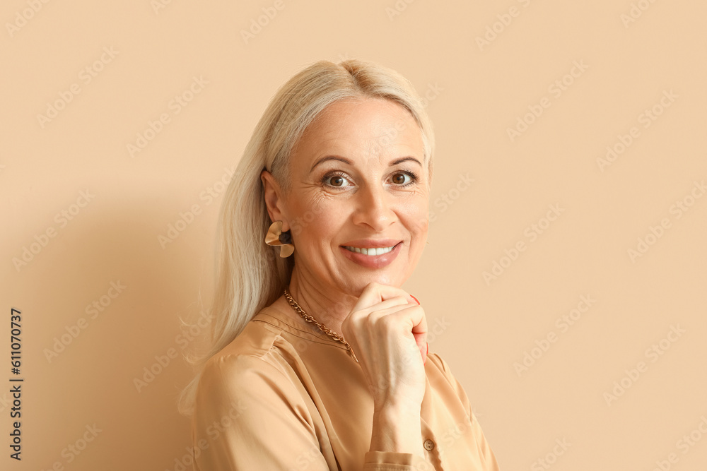 Mature blonde woman on beige background, closeup Mature blonde woman on beige background, closeup
