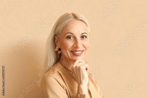 Mature blonde woman on beig...