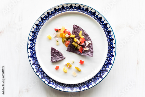Crispy blue corn tortilla chips topped with fresh salsa.