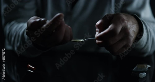 Drugs, hands and syringe, lighter and spoon in studio isolated on a black background. Drug addiction, teaspoon and man with fire, person and junkie cooking dose of heroin, crack or cocaine for crime photo