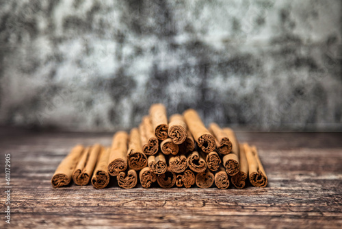 Close-up of ceylon cinnamon sticks on wooden table, rustic style still life. Natural food of sri-lankan cinnamon for poster or banner. Delicious tasty healthy concept. Copy advertising text space