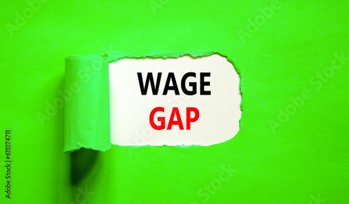 Wage gap symbol. Concept words Wage gap on beautiful white paper on a beautiful green background. Business, support and wage gap concept. Copy space.