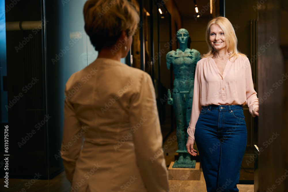 Fototapeta premium Woman smiles affably at gynecologist who came out to meet