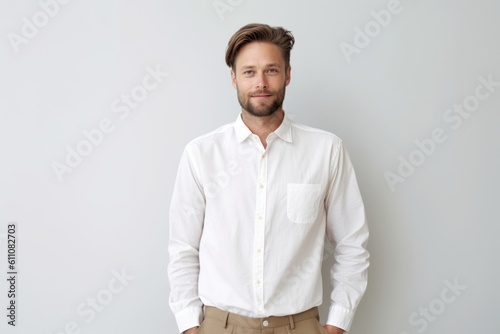 Environmental portrait photography of a glad boy in his 30s wearing an elegant long-sleeve shirt against a white background. With generative AI technology