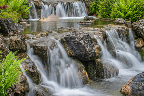 beautiful landscape with waterfall falling from stone wall in japanese style landscape park. Selective focus.