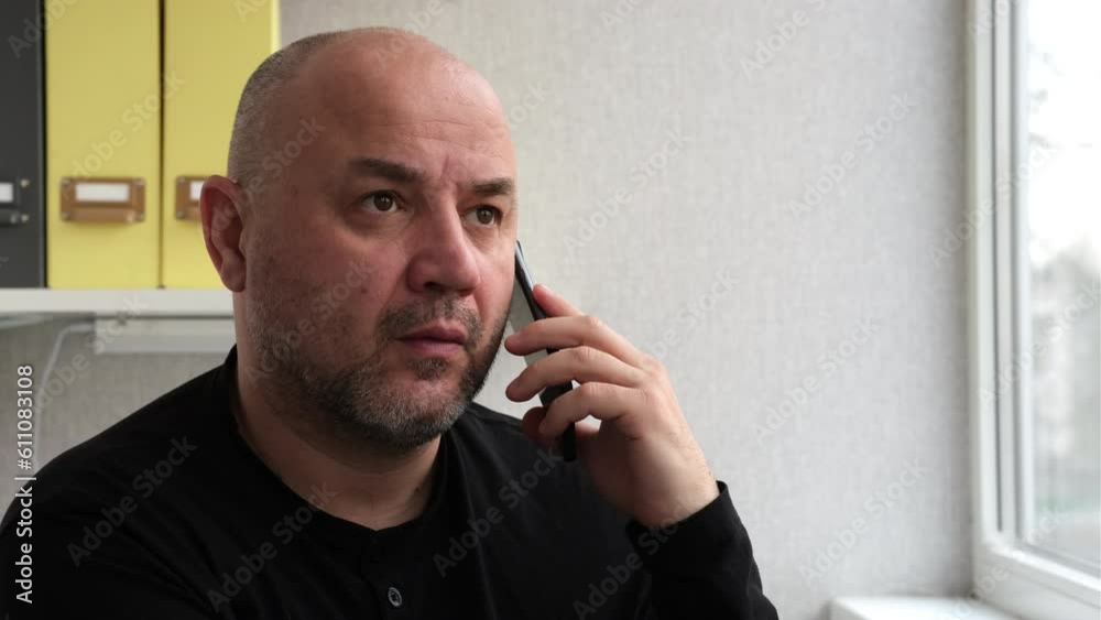 Man talking mobile phone indoors and get surprised. Businessman or worker having phone call at workplace. Portrait of business man calling smartphone Man talking mobile phone indoors and get surprised. Businessman or worker having phone call at workplace. Portrait of business man calling smartphone