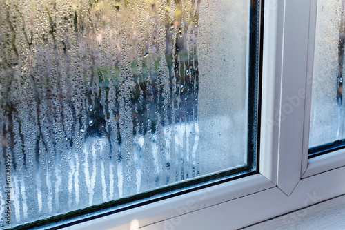 Fotografi Drops of condensation on the metal-plastic window