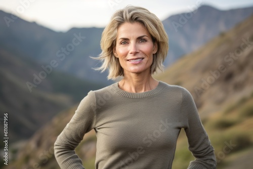 Medium shot portrait photography of a satisfied mature woman wearing an elegant long-sleeve shirt against a scenic mountain trail background. With generative AI technology © Markus Schröder