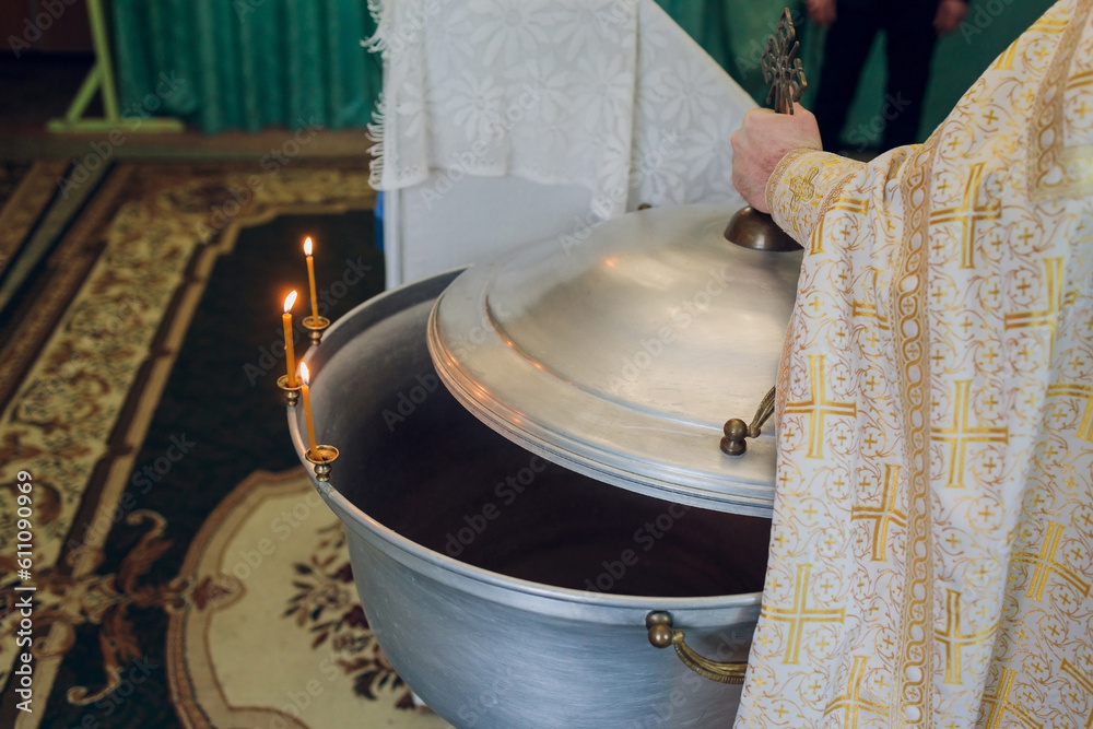 Φωτογραφία Water is poured into the font for bathing the baby in the church, religious traditions