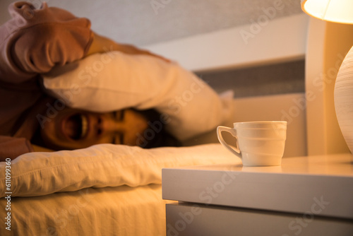 Closeup image of a beautiful young asian woman smelling and drinking hot coffee