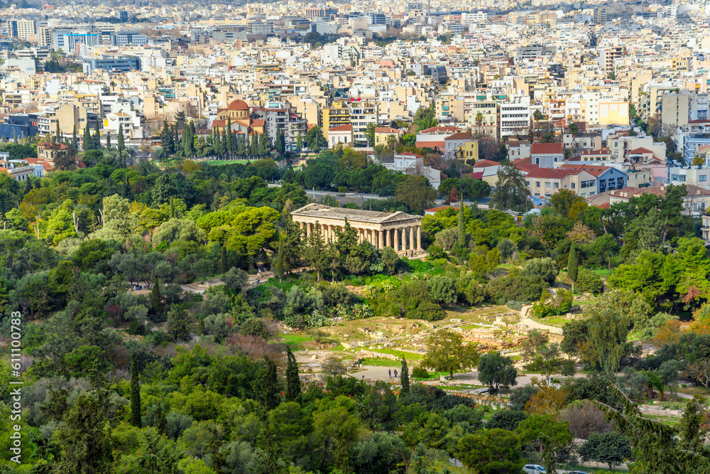 The ancient Greek Temple of Hephaestus rises above the ruins and parks of the ancient agora at the base of the Acropolis Hill in Athens Greece