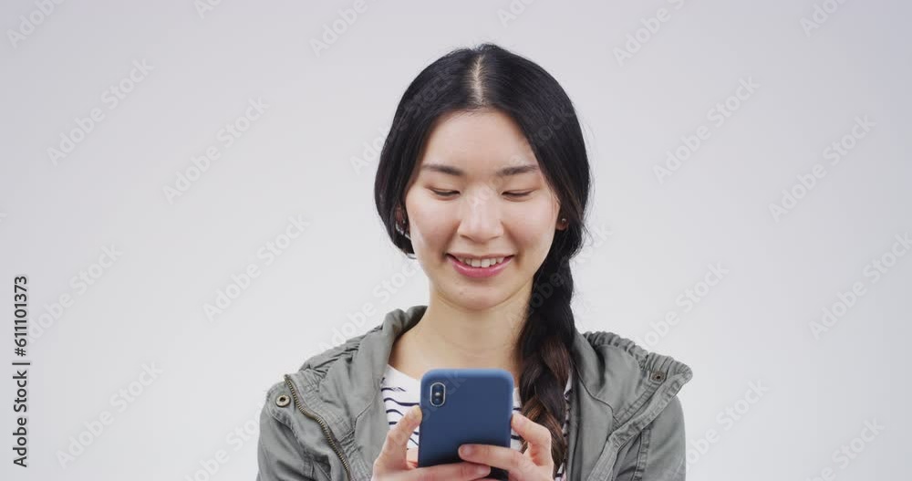Phone, smile and Asian woman typing in studio isolated on a white background mockup space. Cellphone, happy and female person on social media, networking or web scroll, internet browsing and texting Phone, smile and Asian woman typing in studio isolated on a white background mockup space. Cellphone, happy and female person on social media, networking or web scroll, internet browsing and texting