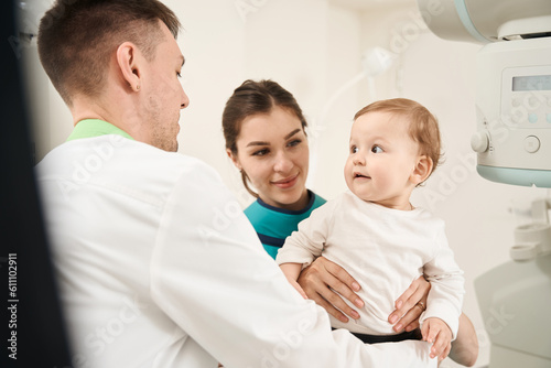 Radiologist getting infant ready for radiography procedure