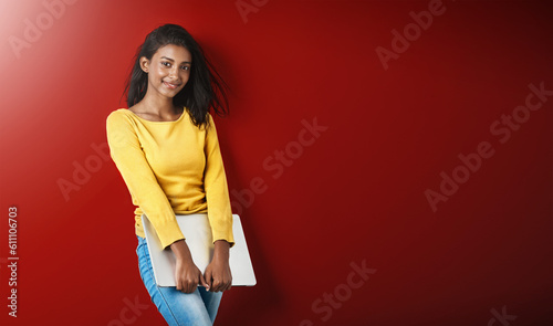 Woman, happy student and portrait with a laptop for university and school work with mockup. Isolated, red background and studio with a young Indian female person with smile and computer for college