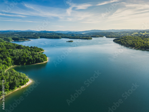 Panoramic view from the drone during sunset, on the Solina Lake over the Solina water dam, in the Polish Bieszczady Mountains, Poland