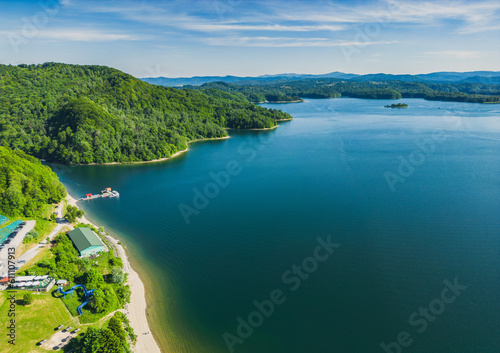 Panoramic view from the drone during sunset, on the Solina Lake over the Solina water dam, in the Polish Bieszczady Mountains, Poland © Daniel