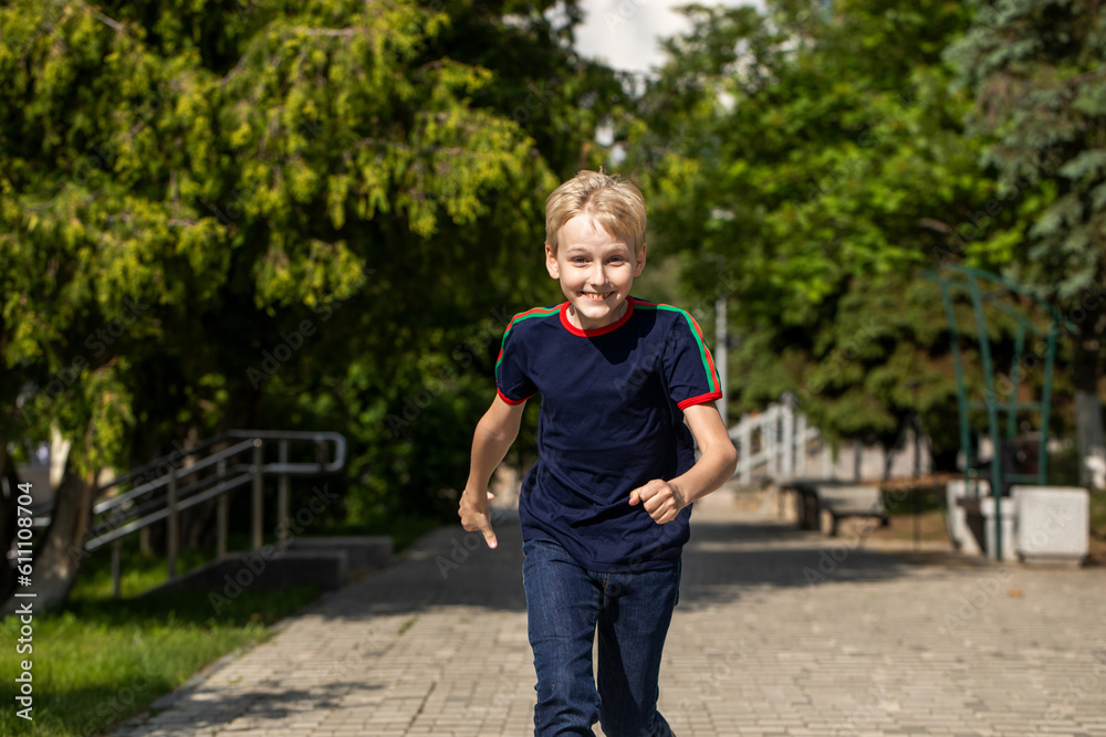 Portrait of a little boy in a summer park