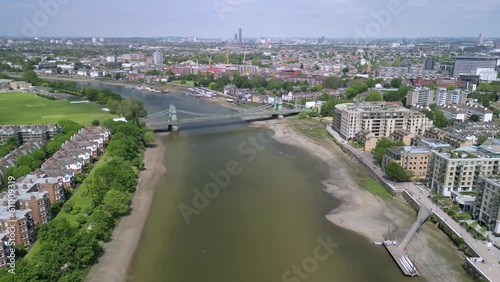 The drone aerial footage of Hammersmith bridge across River Thames in west London, links Hammersmith and Barnes. photo