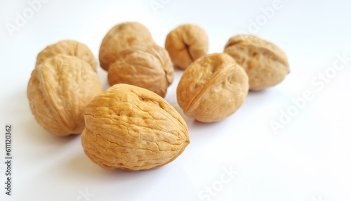 Walnuts on a bright white background with natural lighting. Healthy food, and one of the symbols for the Passover holiday and also for the Tu Bishvat holiday. close up 