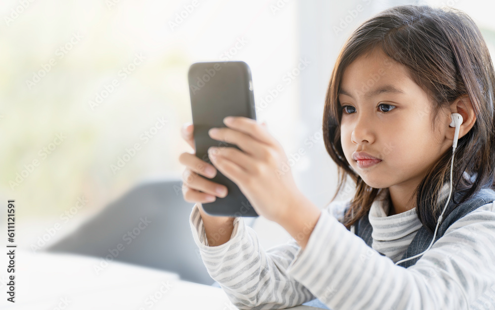 A girl is using a smartphone, learning for new generations of children. A girl is using a smartphone, learning for new generations of children.