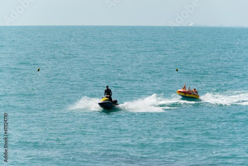 Abkhazia Gagra 08.06.2023 Entertainment at sea, riding on an inflatable boat tied to a jet ski photo