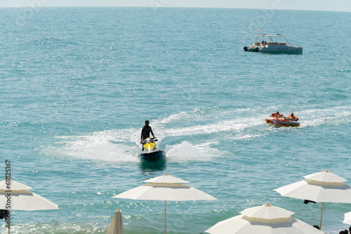 Abkhazia Gagra 08.06.2023 Entertainment at sea, riding on an inflatable boat tied to a jet ski photo