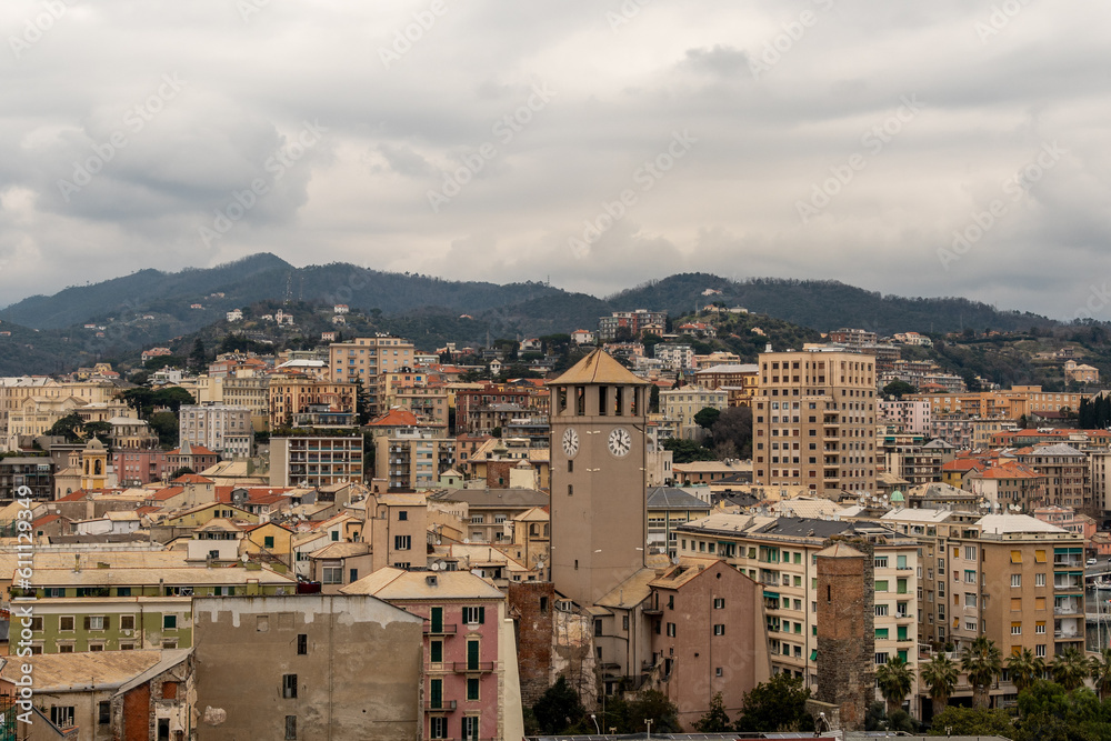 Rooftop cityscape of the coastal city with the Brandale Tower (1100, center) and the Leon Pancaldo Skyscraper (1941, right), in a cloudy day, Savona, Liguria, Italy