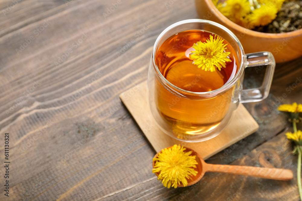 Bowl and glass cup of healthy dandelion tea on wooden background Bowl and glass cup of healthy dandelion tea on wooden background